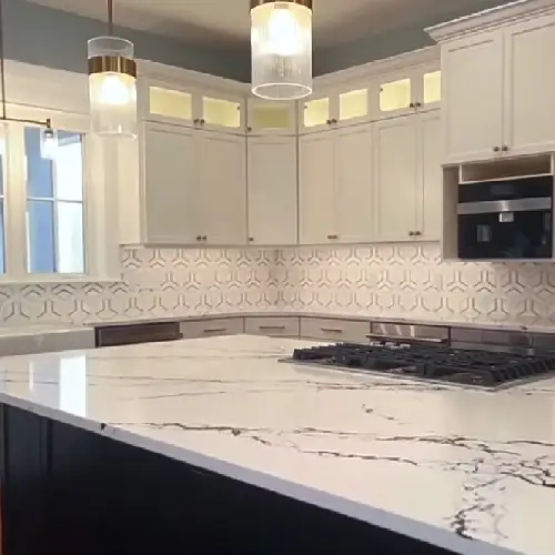 Modern kitchen featuring a spacious marble countertop, sleek cabinetry, decorative tile backsplash, and pendant lighting